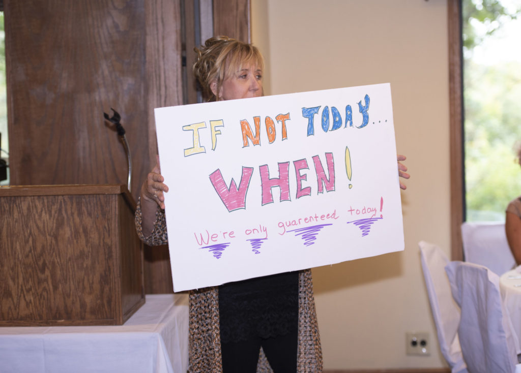 Woman holding if not today when sign